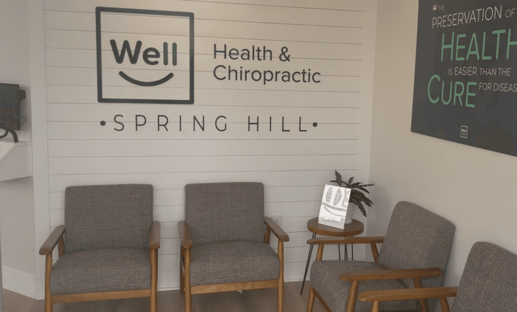 Waiting-room chairs and Well Health & Chiropractic Spring Hill sign
