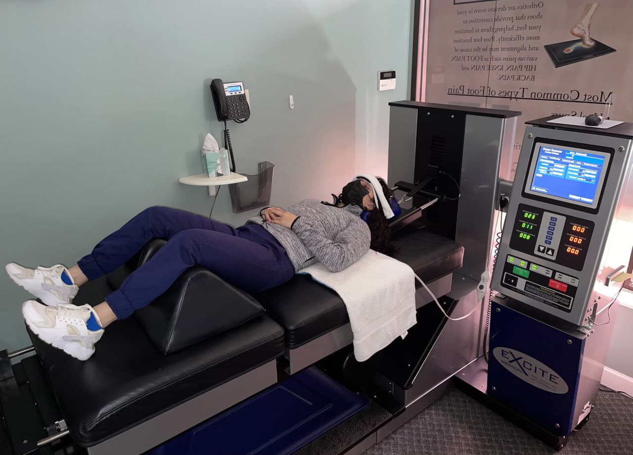 Example of a patient receiving cervical decompression with the neck support attached to a DRX system