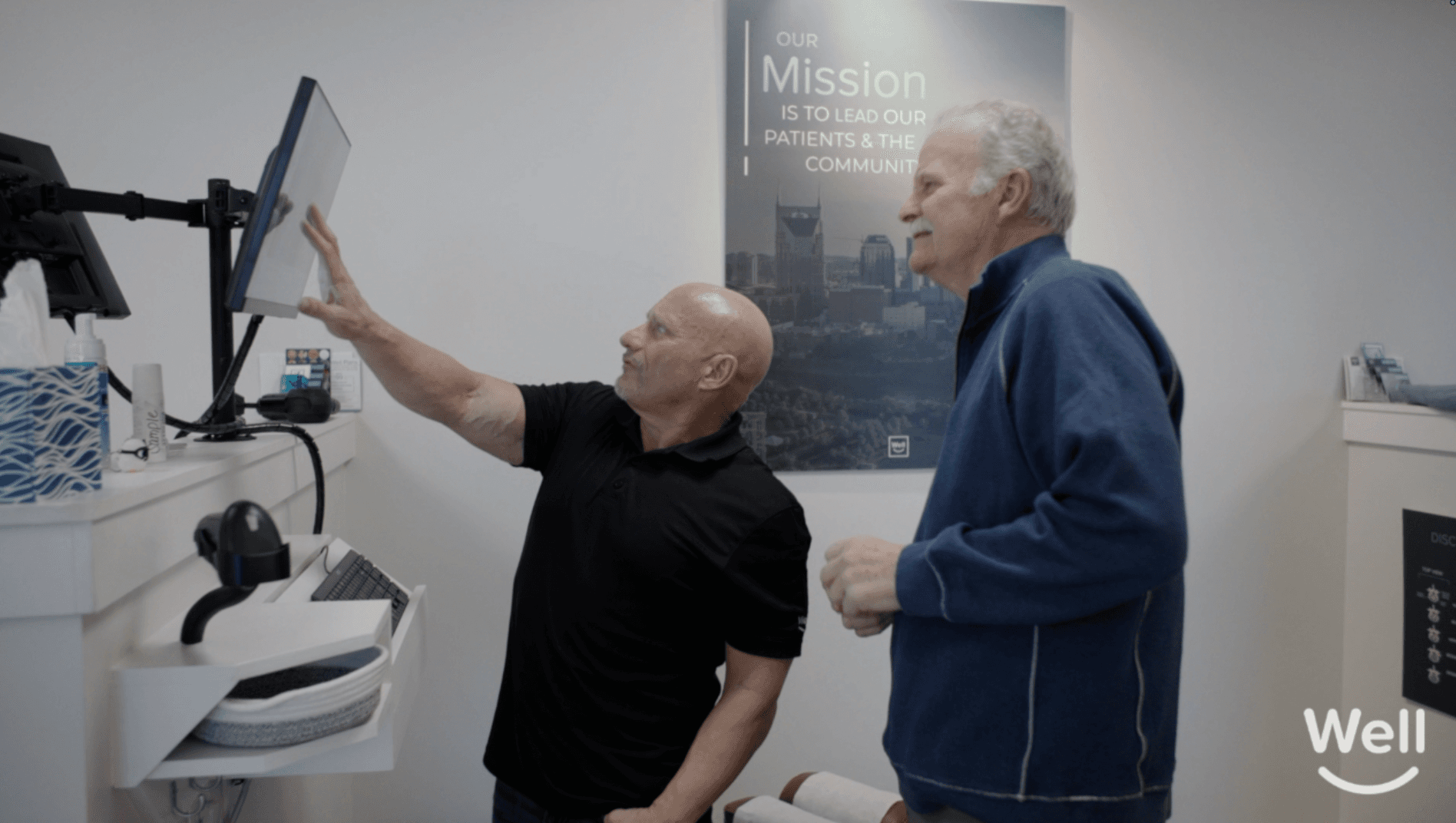 A Well doctor reviewing findings on a monitor with a patient