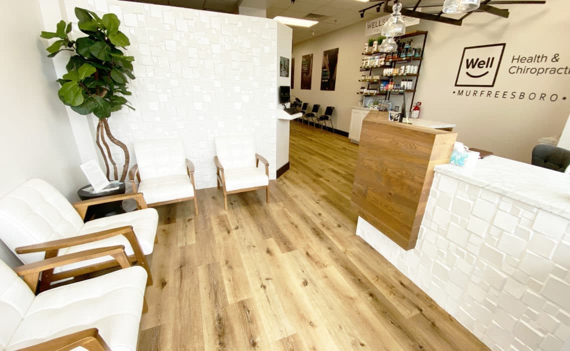 Wood reception desk and waiting area at Well Health & Chiropractic Murfreesboro