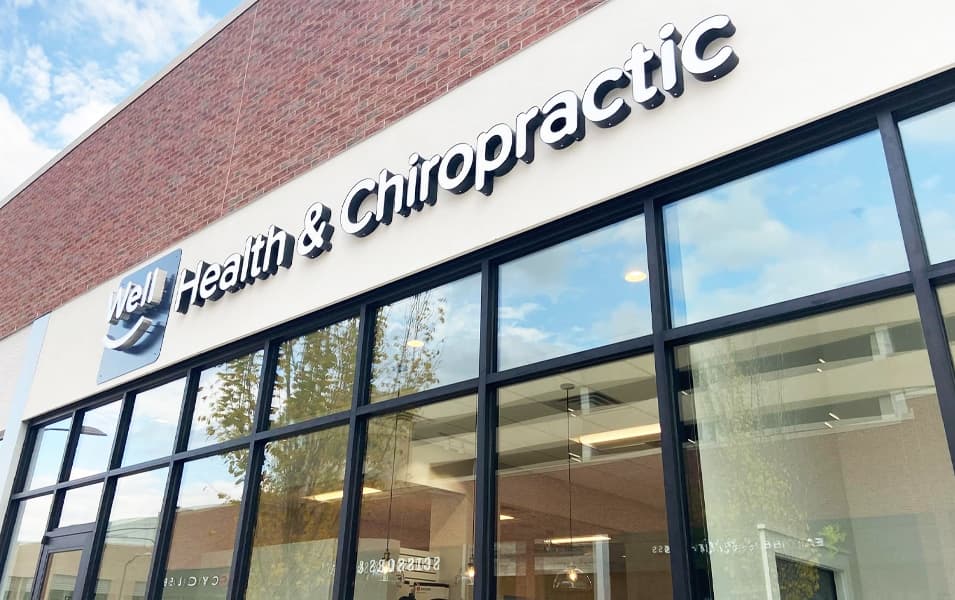 Glass-front entrance and exterior signage at Well Health & Chiropractic Brentwood