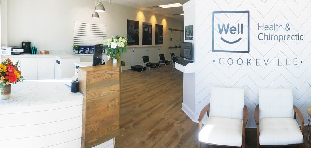 Reception desk and white seating at Well Health & Chiropractic Cookeville