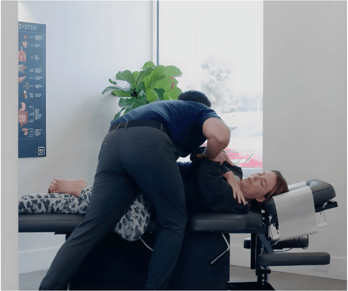 Doctor performing a chiropractic adjustment on a patient.