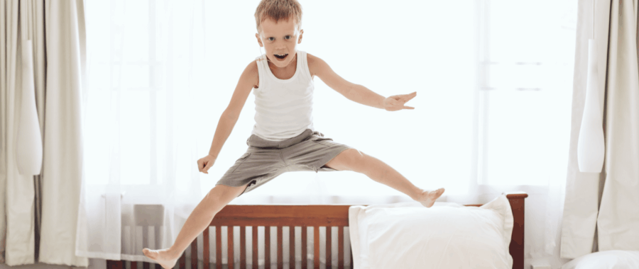 Child jumping on a bed