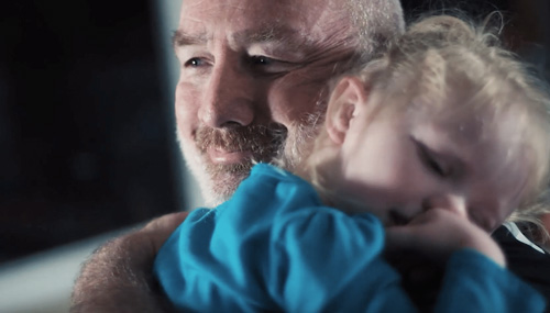 Well health patient, Jimmy, holding his daughter